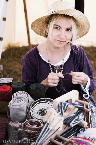 Woman doing naalbinding with a bone needle